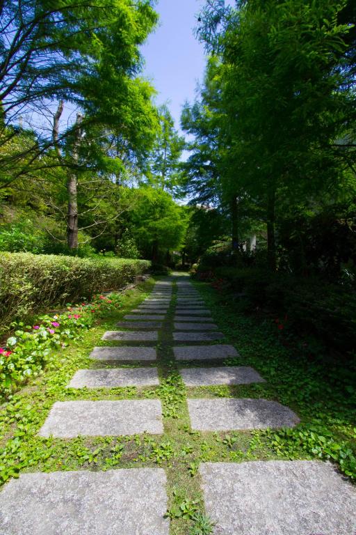 a stepping stone path in a park with trees at Yun Wu B&amp;B in Ren&#39;ai