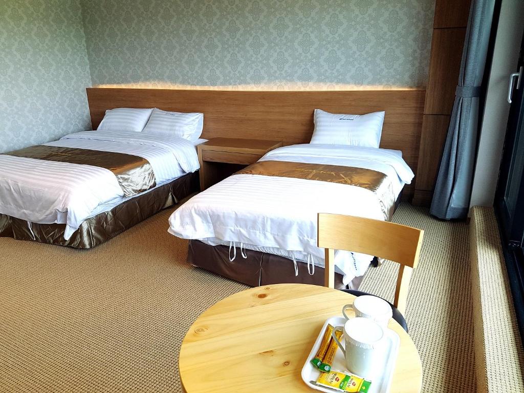 Postel nebo postele na pokoji v ubytování YangYang International Airport Hotel