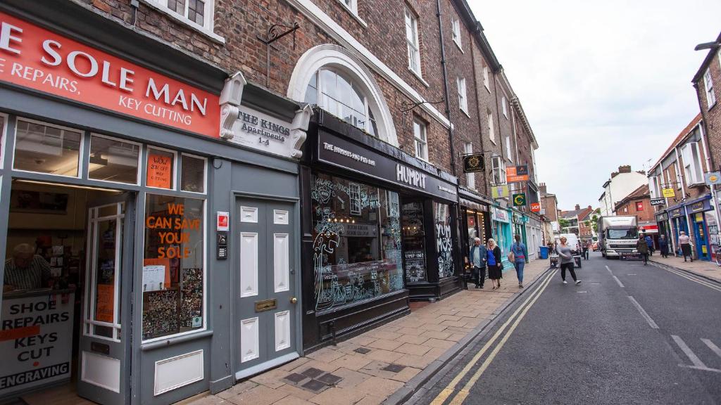 a street with buildings and people walking down the street at The King's- Gorgeous City Centre Apartment in York