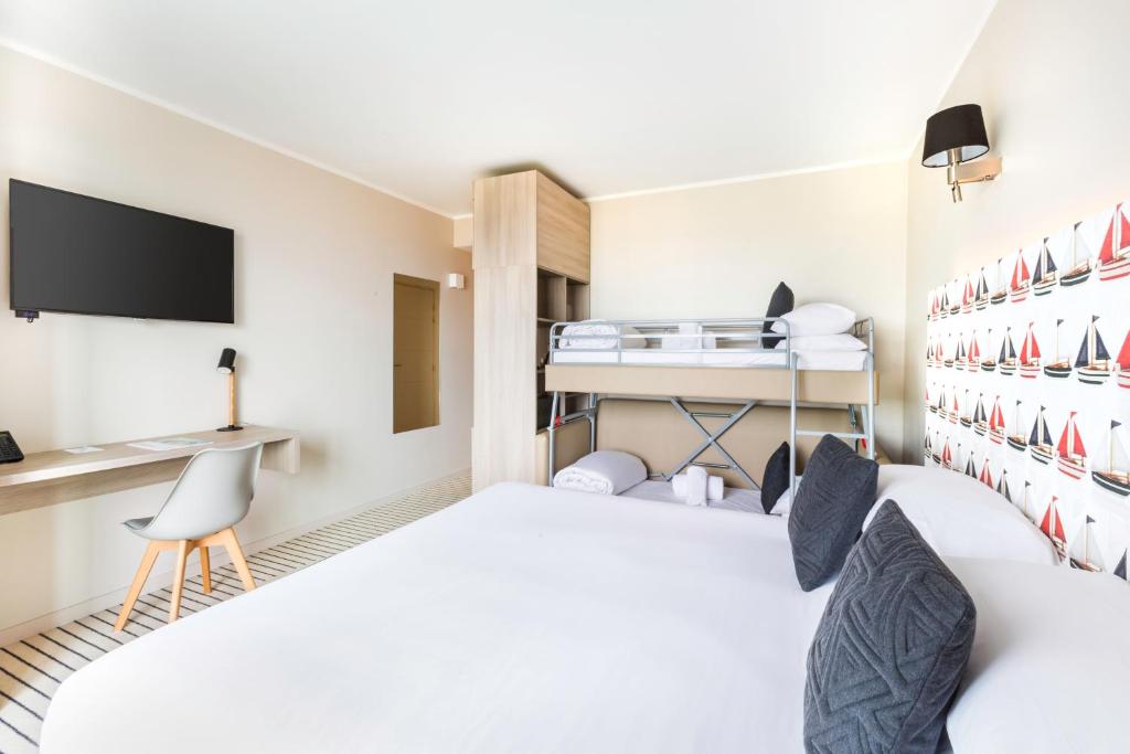 a hotel room with a bed and a desk at Best Western Plus Antibes Riviera in Antibes