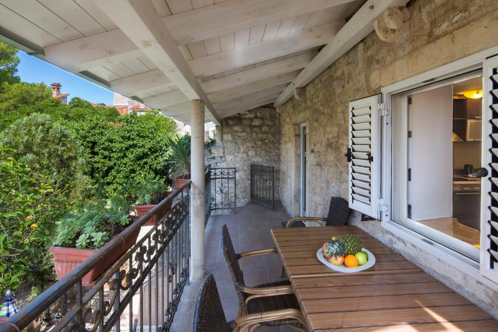 a patio with a table and chairs on a balcony at Apartment Kovacevic Old Town in Budva