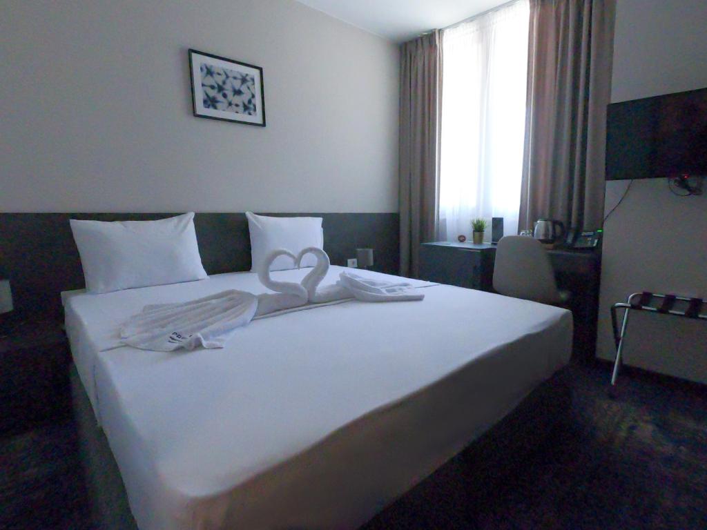 Postel nebo postele na pokoji v ubytování Hotel Premium