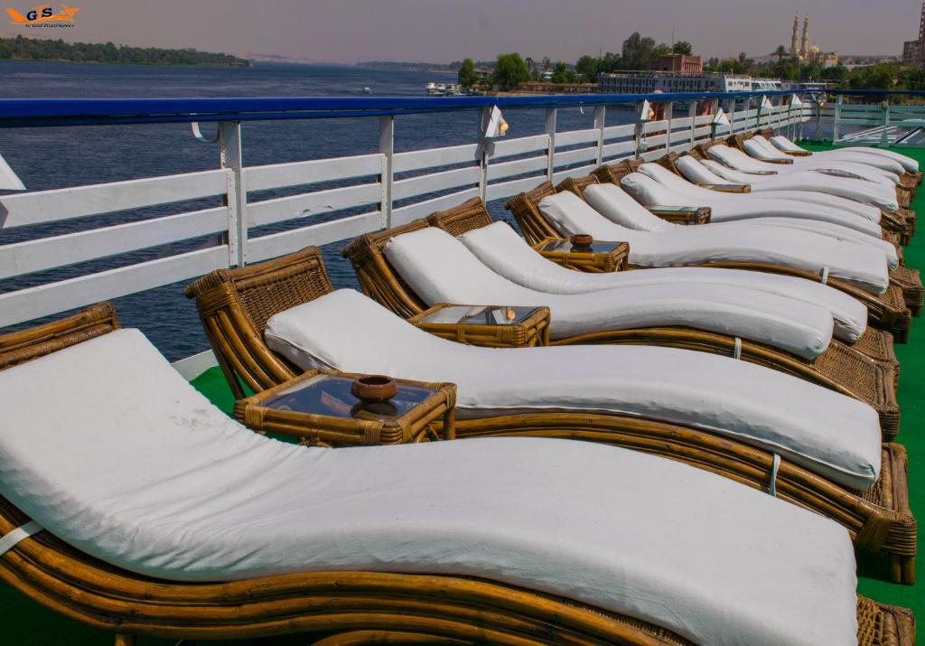 a row of wicker chairs on a cruise ship at Nile Cruise Luxor Aswan 3,4 and 7 nights in Aswan