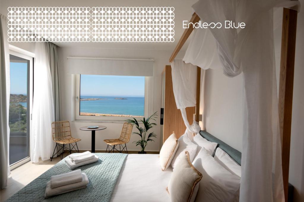 a bedroom with a bed with a view of the ocean at Endless Blue in Palaiochora