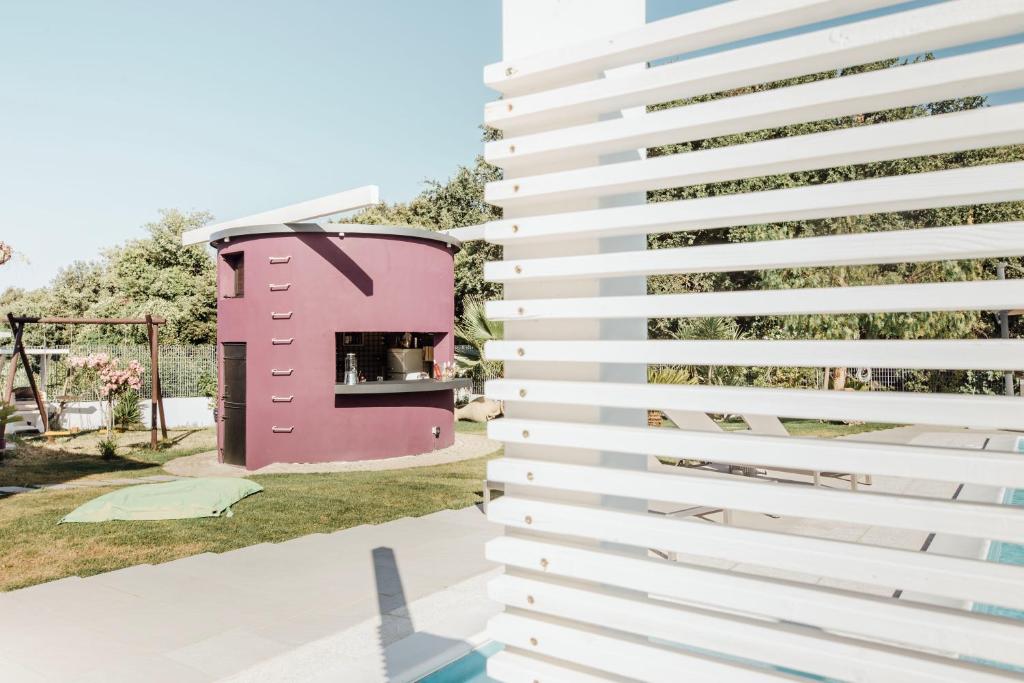 a rendering of a pink and white building at Suite 106 in Vasto