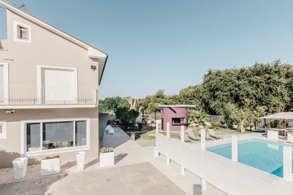 a villa with a swimming pool and a house at Suite 106 in Vasto