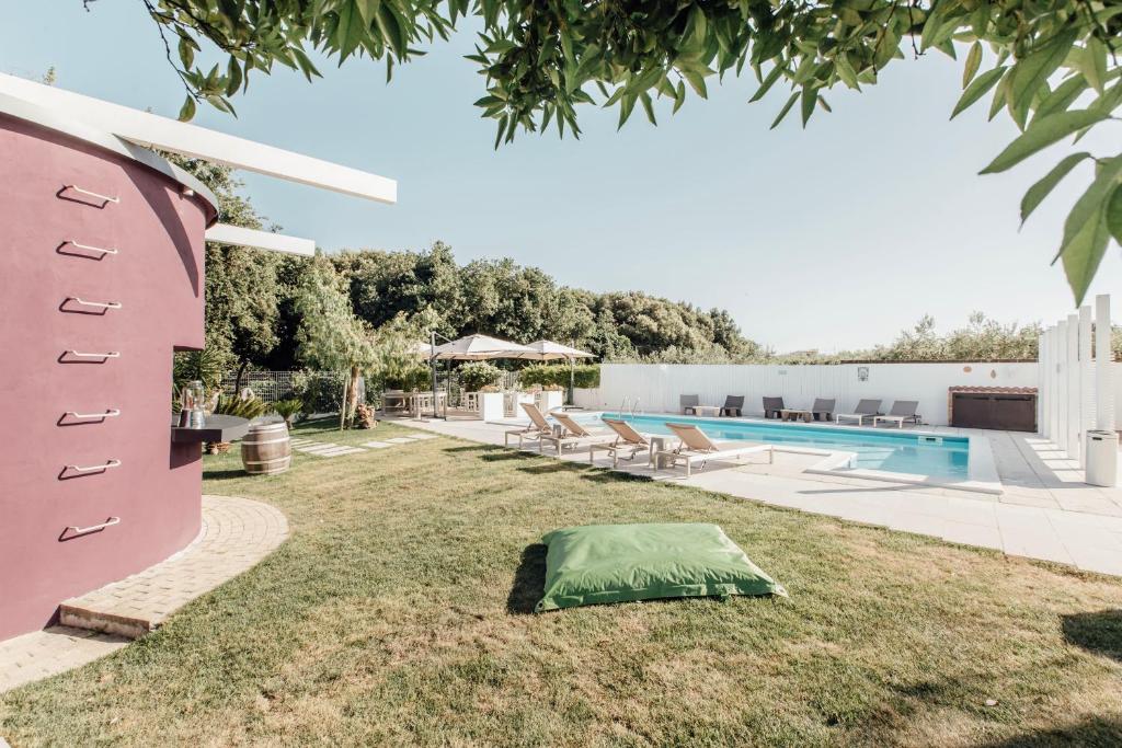 a tent on the grass next to a swimming pool at Suite 106 in Vasto