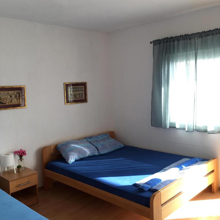 Postel nebo postele na pokoji v ubytování Apartment and Rooms Barbaric