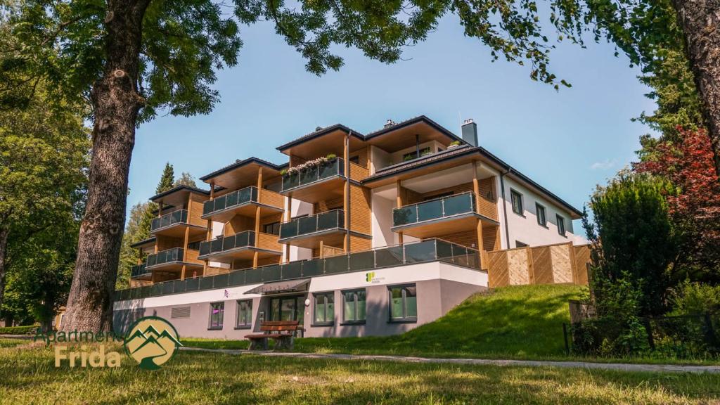 a large building on a hill with trees at Apartment Frida by Da Alois in Gröbming