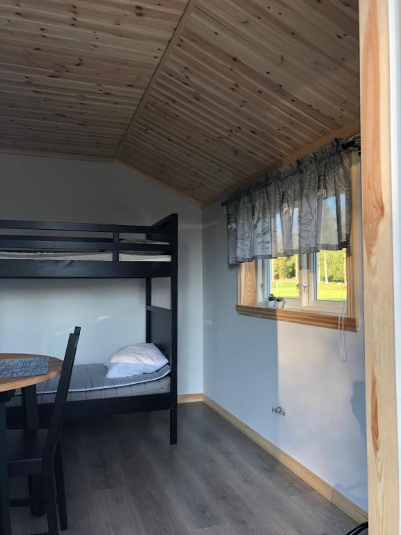 a room with bunk beds and a table at Sörmarks Camping in Sörmark