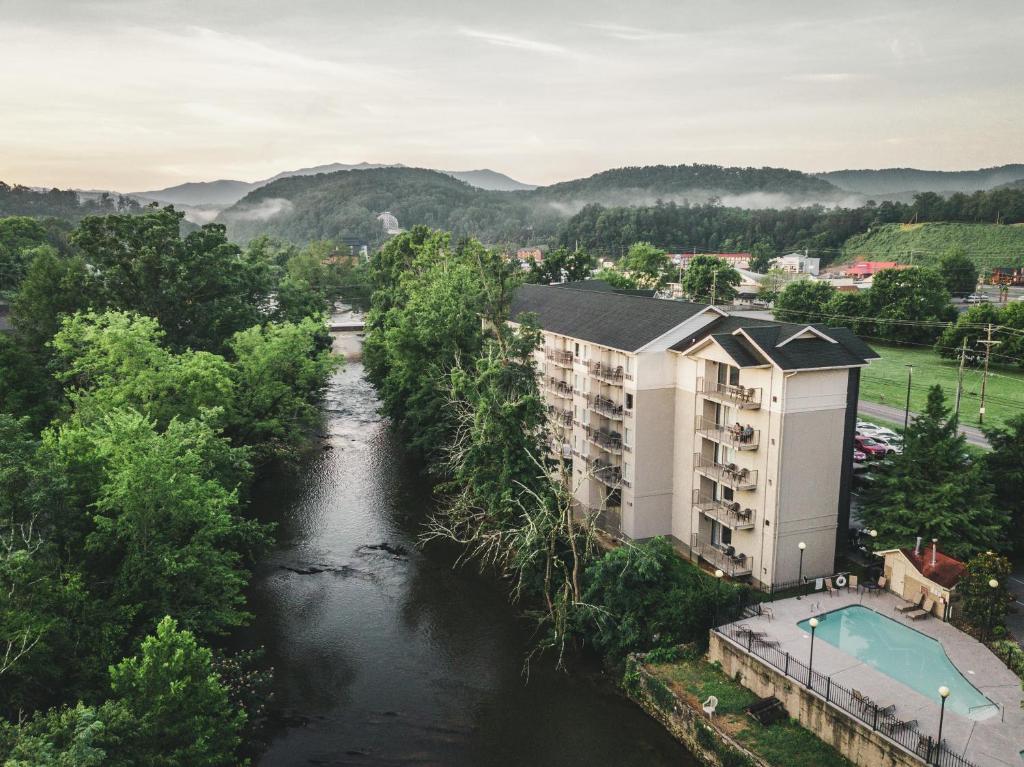 an aerial view of a river with a building at Twin Mountain Inn & Suites in Pigeon Forge