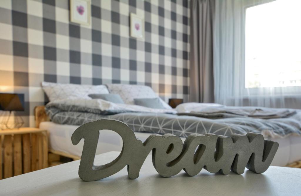 a bedroom with a bed with a sign that says run at Apartament Dzień Dobry 2 in Wałbrzych