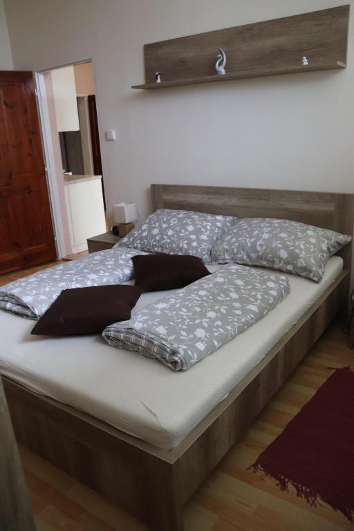a bed with pillows on it in a bedroom at Apartmán Lux Prešov in Prešov