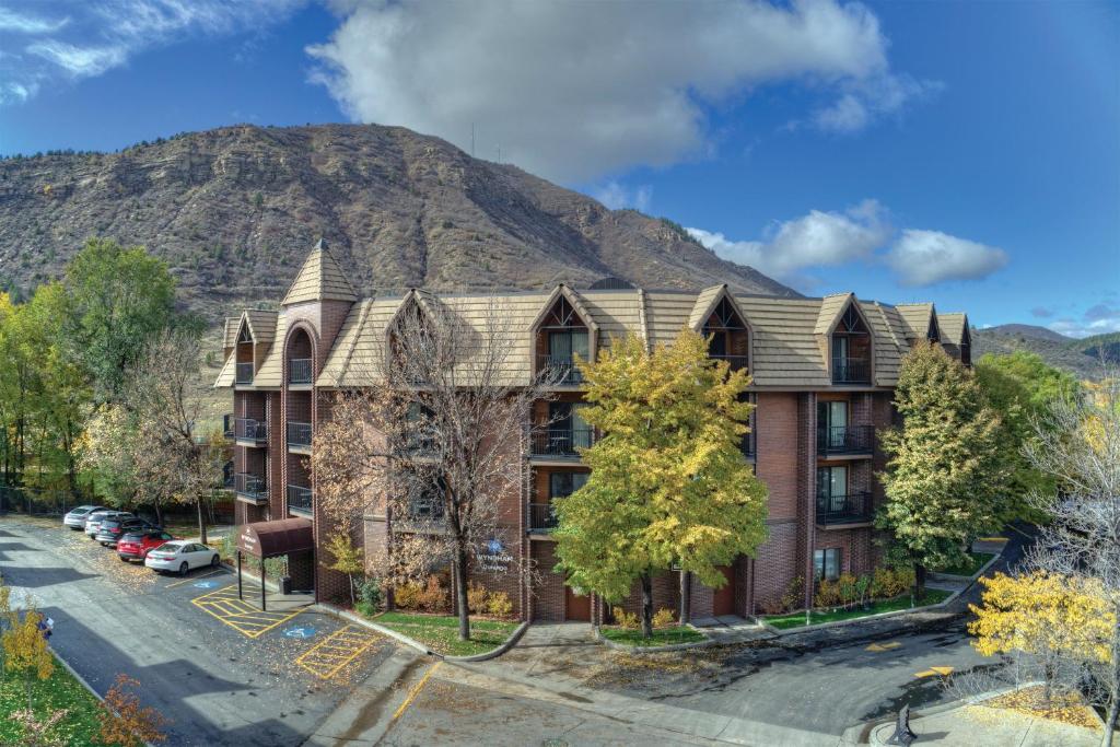 an apartment building with a mountain in the background at Club Wyndham Durango in Durango
