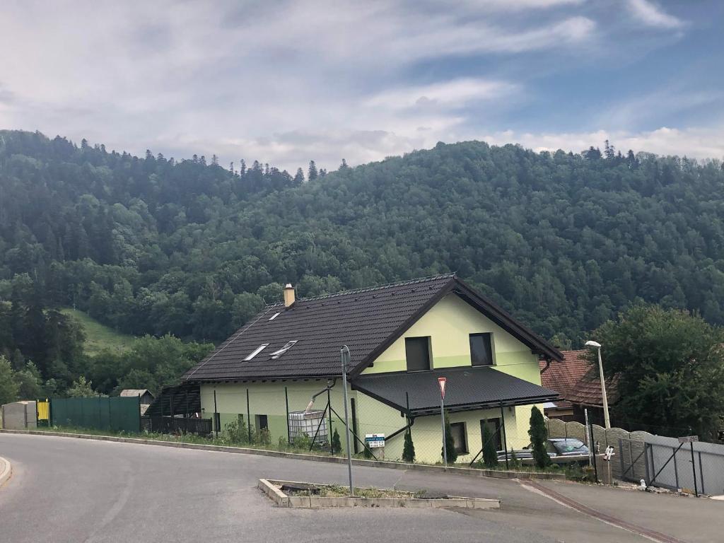 a house on the side of a road with a mountain at Privát Miško in Levoča