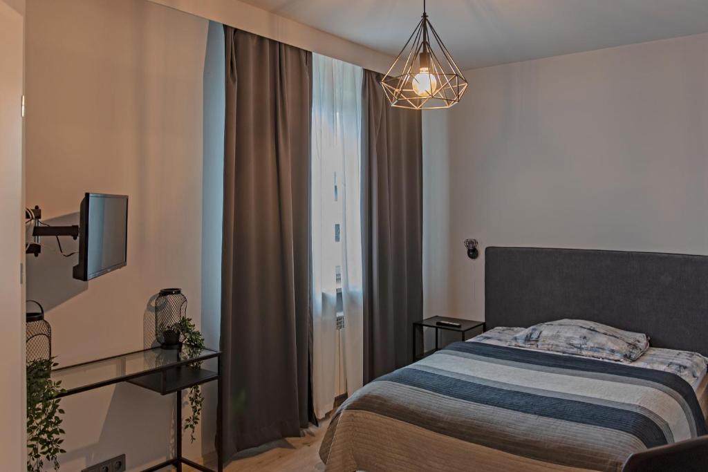 Habitación de hotel con cama y TV en Aparthotel STUDIO, en Cracovia