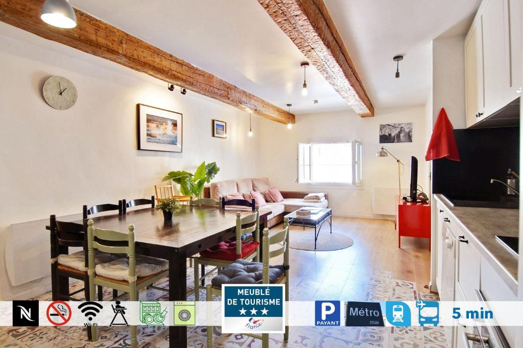 a kitchen and living room with a dining room table at Les marches de St Charles - 100M2 in Marseille