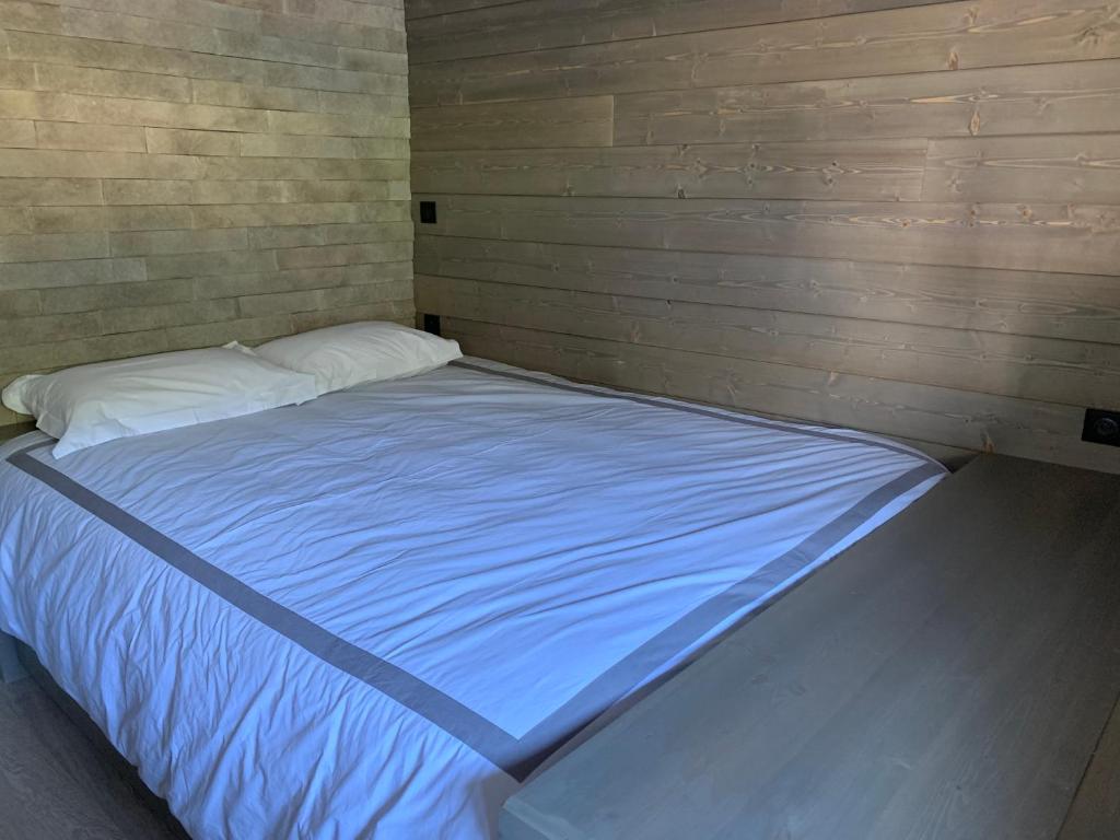 a large bed in a corner of a room at GITES SAINT ROMARY in Saint-Étienne-lès-Remiremont