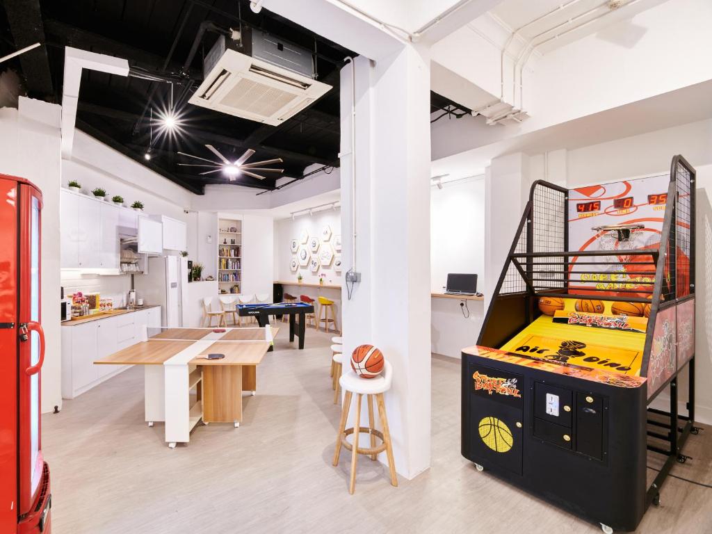 a room with a ping pong game and a table at BEAT. Sports Hostel in Singapore