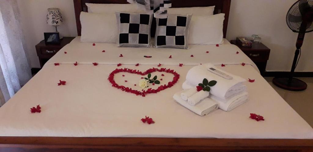 a bed with a heart made out of towels at Yaluwa Tourist Rest & cooking class in Anuradhapura