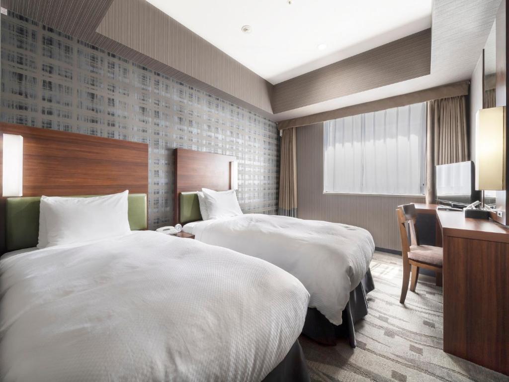 Postel nebo postele na pokoji v ubytování Sotetsu Grand Fresa Tokyo-Bay Ariake