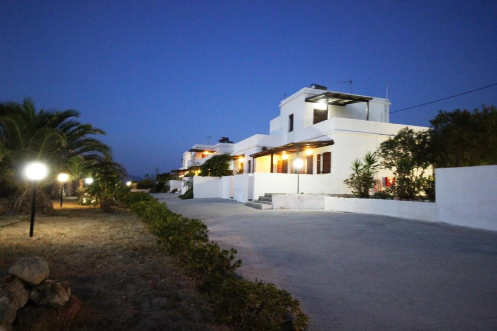 a white building at night with a street light at Galini in Agia Irini Milos
