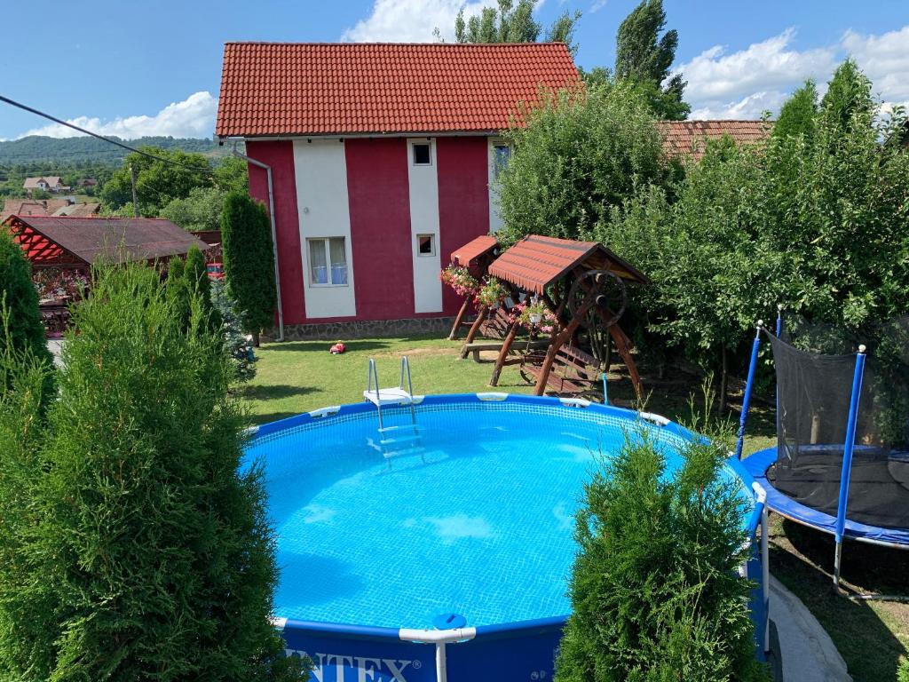 a swimming pool in the yard of a house at Pensiunea Robi&Norbi Sovata in Sovata