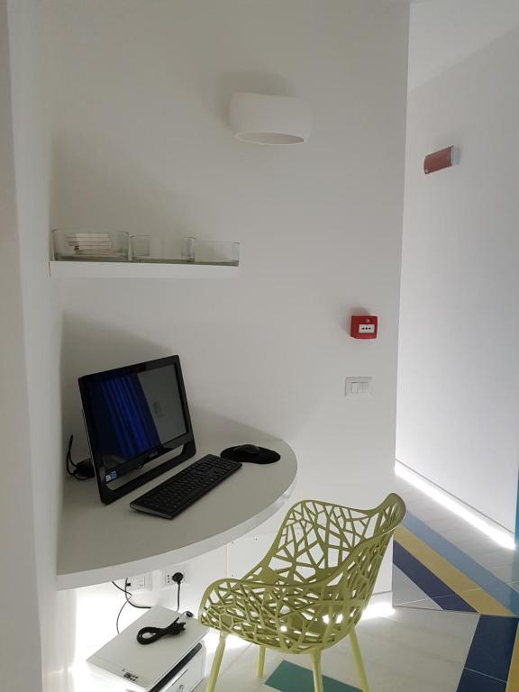 a laptop computer sitting on a desk with a chair at BLU SEA SORRENTO in Sorrento