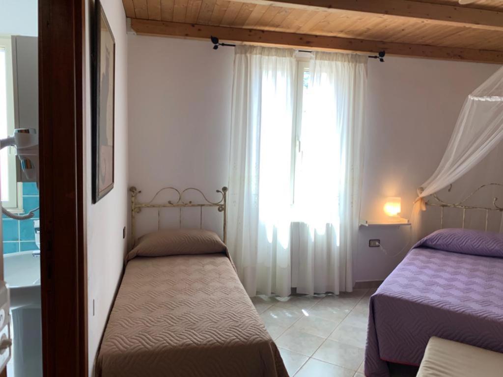 Postel nebo postele na pokoji v ubytování B&B S'Incontru