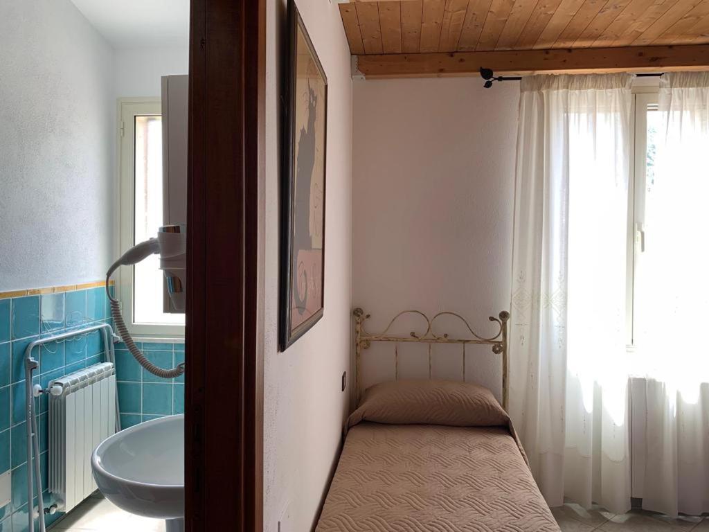 Postel nebo postele na pokoji v ubytování B&B S'Incontru