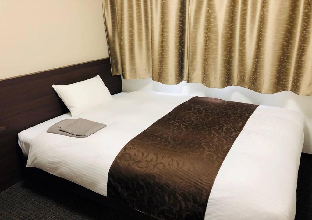 Postel nebo postele na pokoji v ubytování AI HOTEL Hashimoto