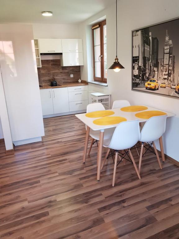 a kitchen and dining room with a table and chairs at Apartament Nad Łomnicą in Karpacz