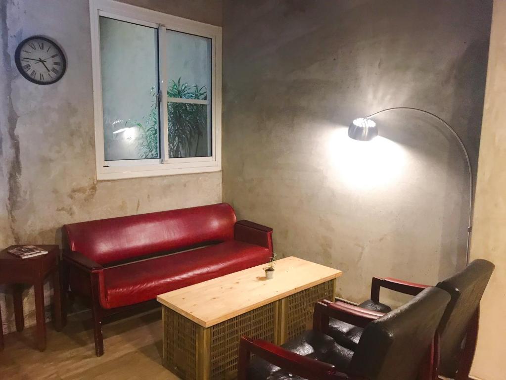 a waiting room with a red bench and a window at Prince Hotel in Chiayi City