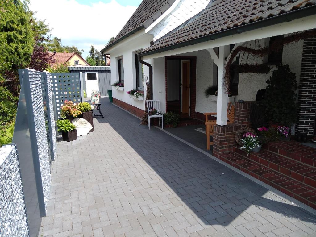 a porch of a house with a brick sidewalk at Tauchparadies Kreidesee in Hemmoor