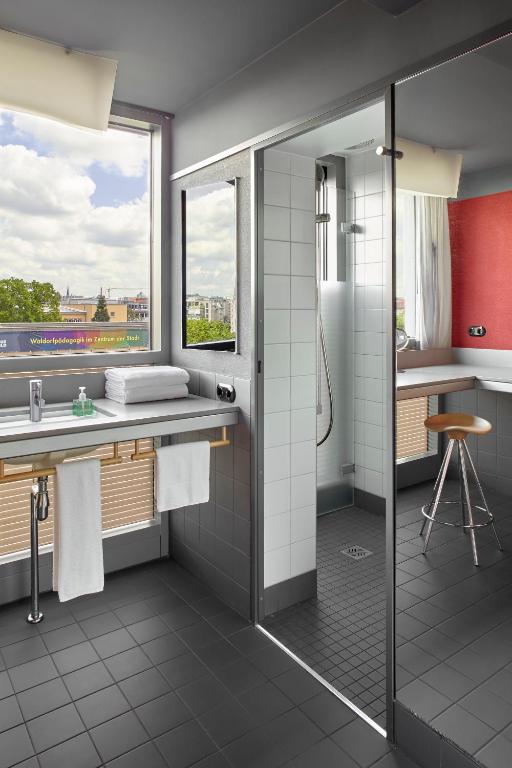 a bathroom with a shower and a sink at Casa Camper Berlin in Berlin