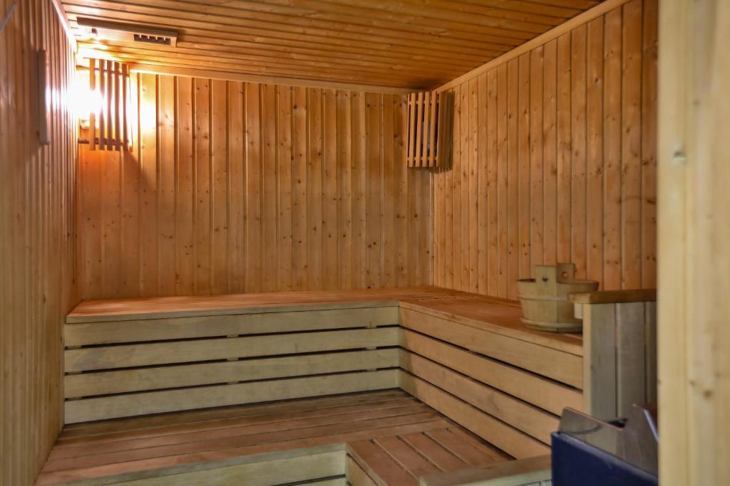 a wooden sauna with a bench in the middle at Oceania Bay Village in Pyla