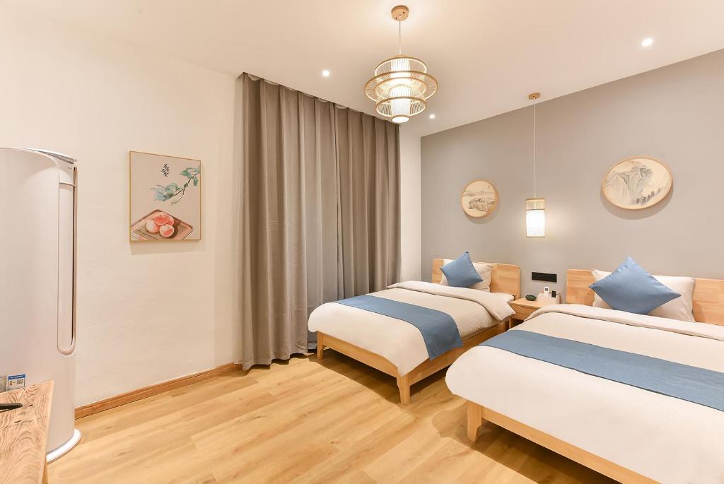 Postel nebo postele na pokoji v ubytování Yifangyan - Tingyuan Qingshe Hostel