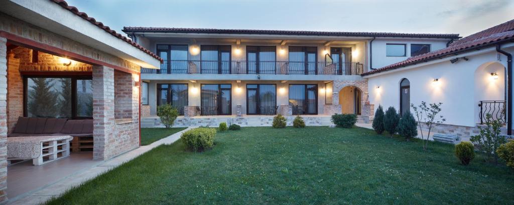 a large house with a lawn in front of it at Sea View Vama Veche in Vama Veche