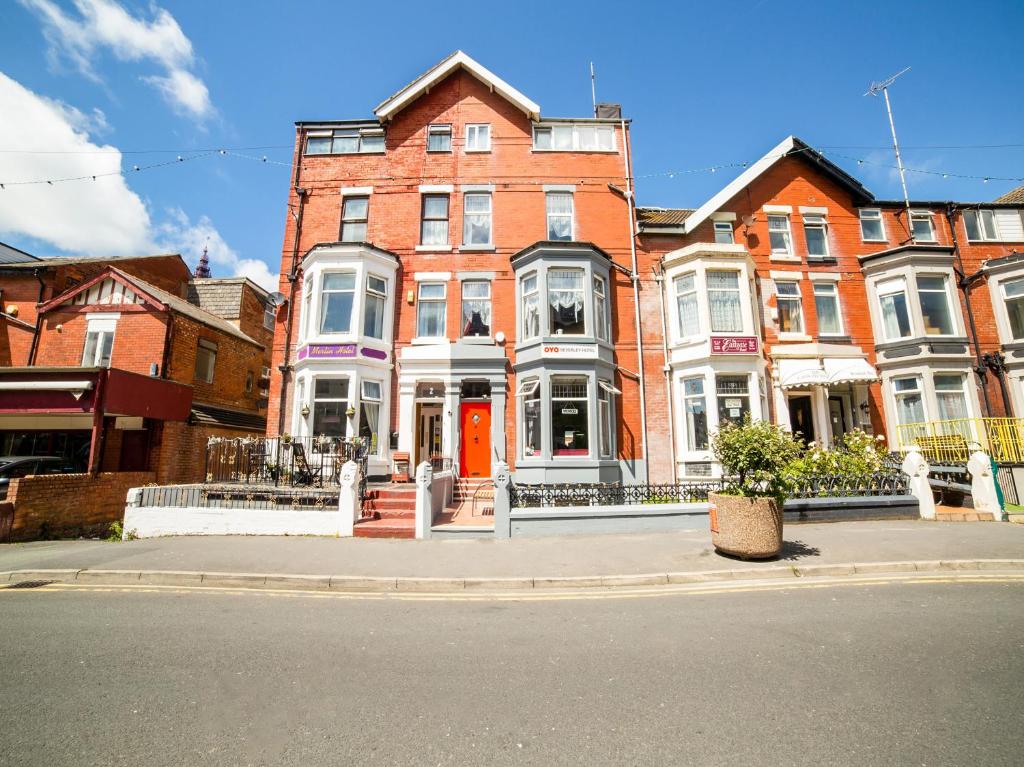 a row of brick houses on a city street at PRESTIGE PLAZA Hotel in Blackpool