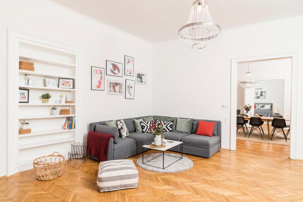 a living room with a couch and a table at Rainer Maria Rilke Suite in Vienna