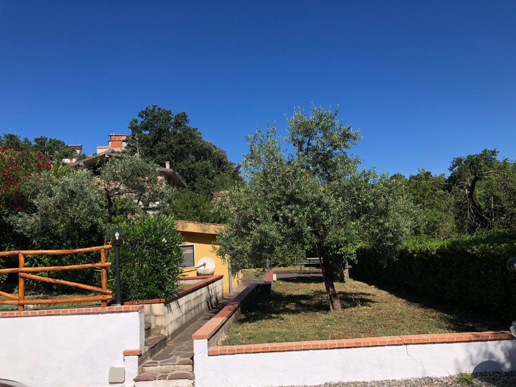 a house with a yard with trees and a fence at Casa Vacanze Nonna Suocera in San Severino