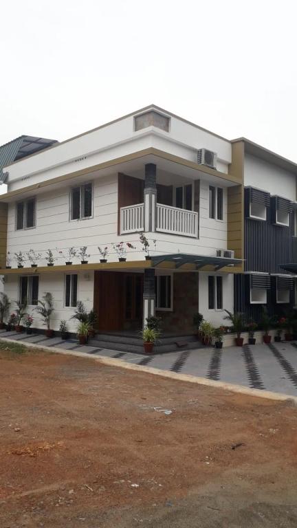 a large white building with a balcony on it at GOLDEN VILLA in Cochin