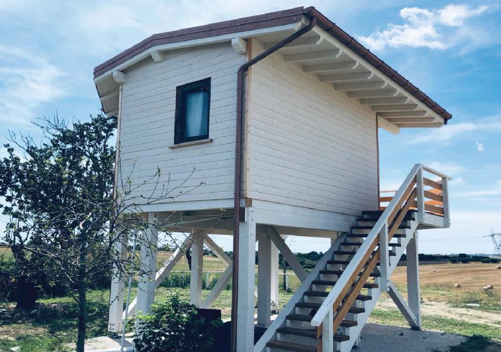 a tiny house with a staircase leading up to it at Corte Franca La Nuova Era in Tragliata