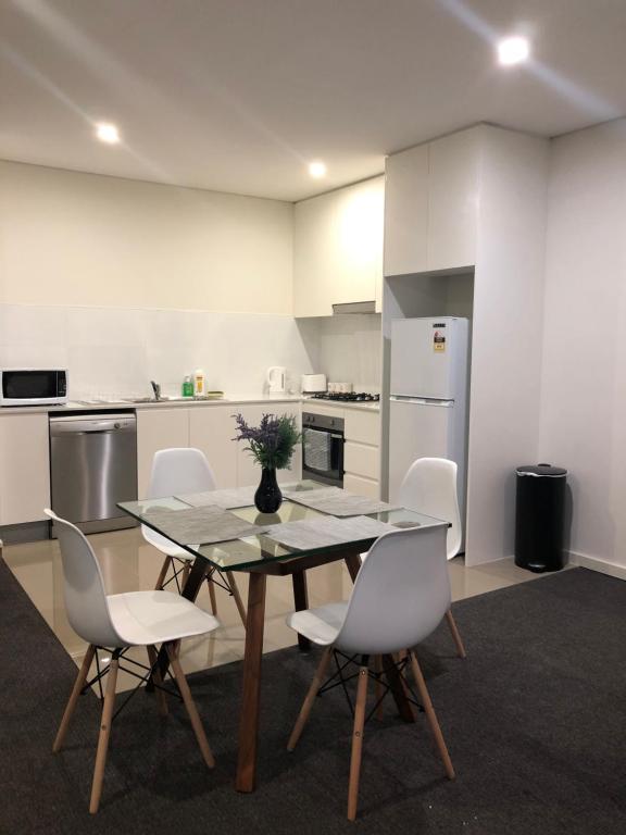a dining room with a table and chairs in a kitchen at Modern Apartment in Liverpool CBD in Liverpool