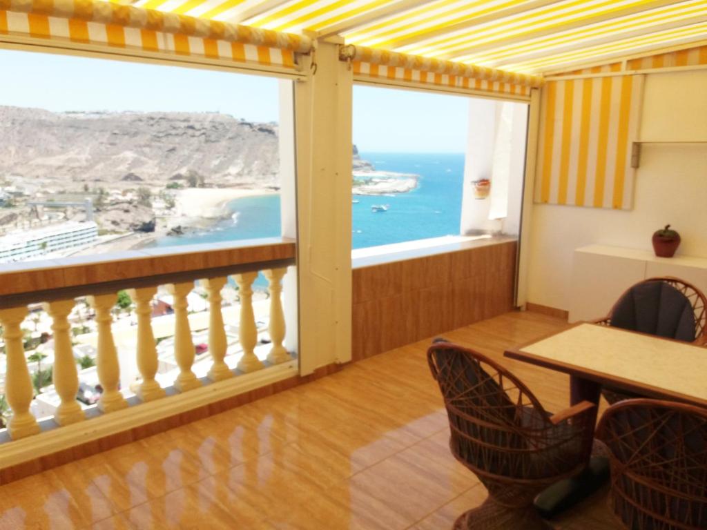 a room with a balcony with a view of the ocean at Apartamento Alegria in Playa del Cura