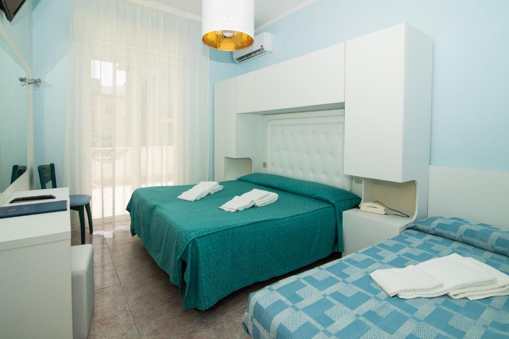Postel nebo postele na pokoji v ubytování Hotel Giovanella
