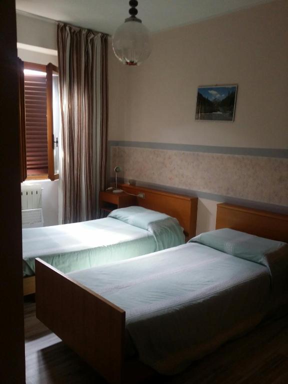 Postel nebo postele na pokoji v ubytování Albergo la Valle