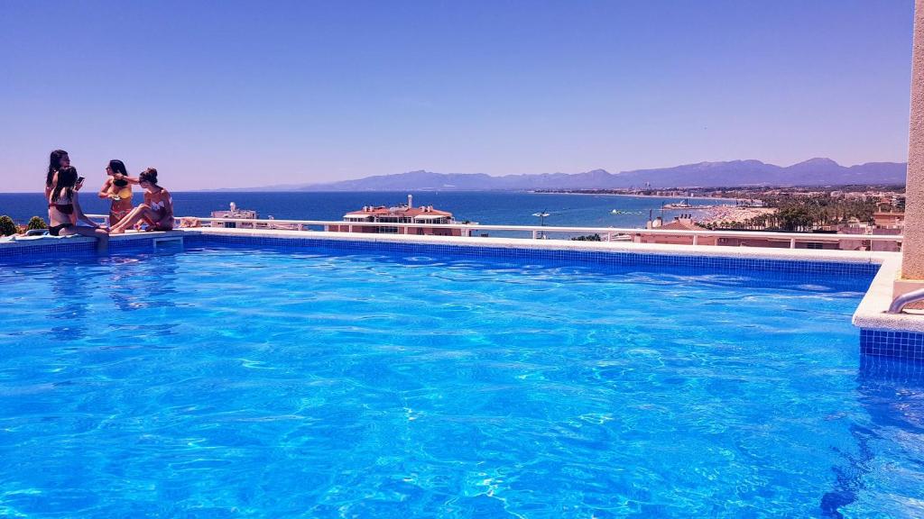 un grupo de personas de pie alrededor de una gran piscina en Central Park Salou VIP, en Salou