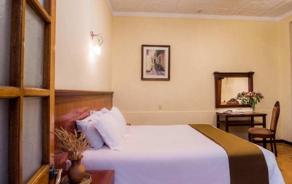 Postel nebo postele na pokoji v ubytování Majestad Hotel Boutique