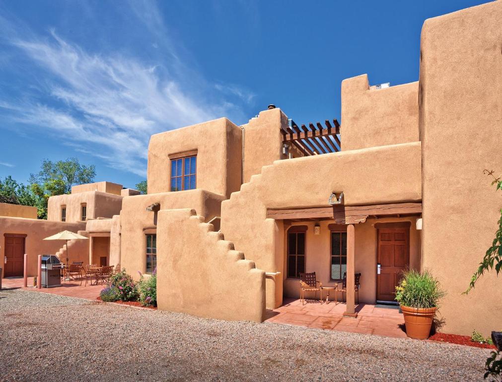 a building in the desert with tables and chairs at WorldMark Santa Fe in Santa Fe